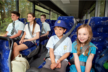 School kids wearing seatbelts on the bus